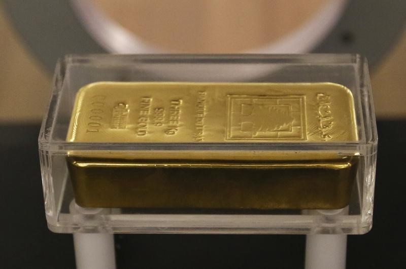 Gold Falls as Stronger Dollar and Inflation Data Weigh on Prices